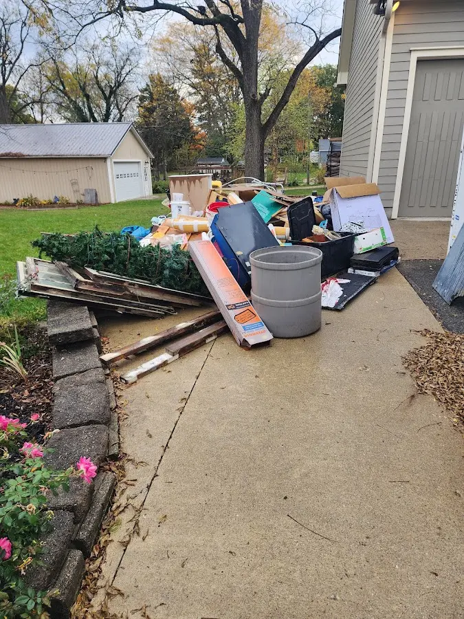 Dumpster being loaded with debris for Estate Cleanout Dumpster Rental in Glen Raven
